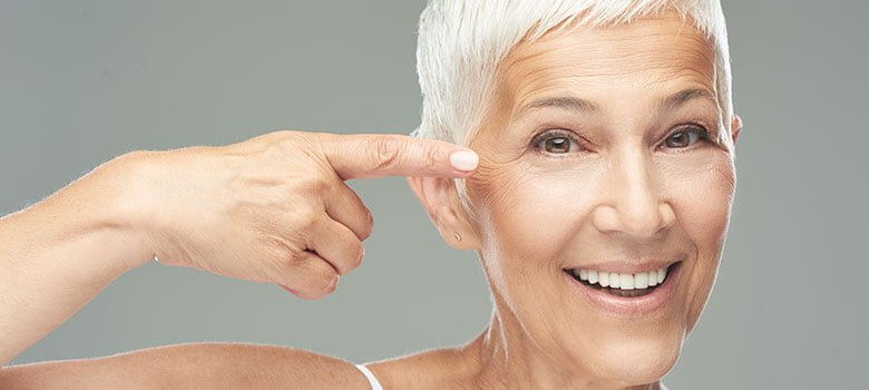 collagen refresh woman pointing at her youthful face